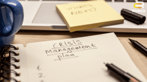 Notepad with written text "Crisis Management Plan"