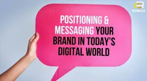Human hand holding cardboard sign with text overlaying that says "Positioning and Messaging Your Brand in Today's Digital Space".