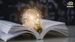 An open book with a shining light bulb on top of it.
