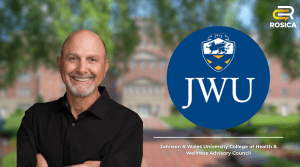 Chris Rosica in front of a blurred JWU building with the JWU Logo next to him