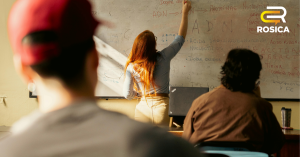Teacher Writing on a Board in Classroom