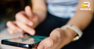 Person scrolling on phone; article image for rosica blog on social media benchmarks for nonprofits.